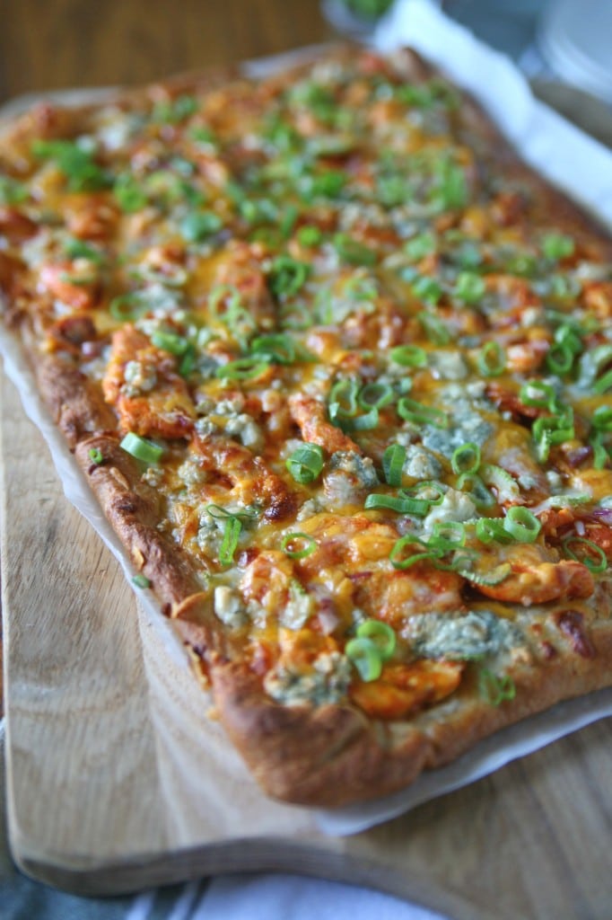 Buffalo Chicken Pizza | BourbonAndHoney.com -- A spicy buffalo chicken pizza topped with layers of cheese. The perfect dinner for buffalo wing lovers or appetizer for a crowd on game day.