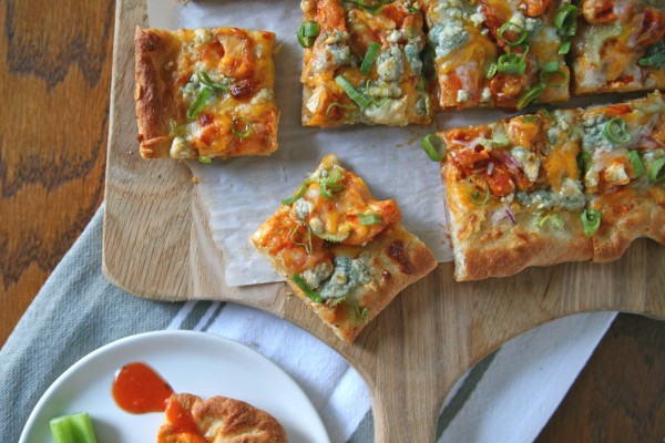 Buffalo Chicken Pizza | BourbonAndHoney.com -- A spicy buffalo chicken pizza topped with layers of cheese. The perfect dinner for buffalo wing lovers or appetizer for a crowd on game day.