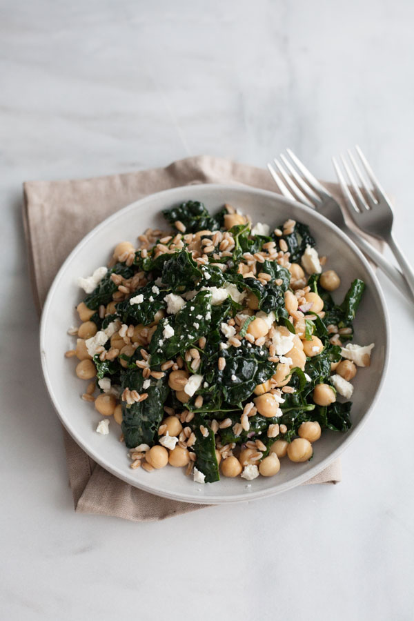 Kale and Farro Salad with Chickpeas | BourbonandHoney.com -- Fresh, hearty and delicious, this Kale and Farro Salad is packed with kale, a light lemon dressing and a sprinkling of feta cheese.