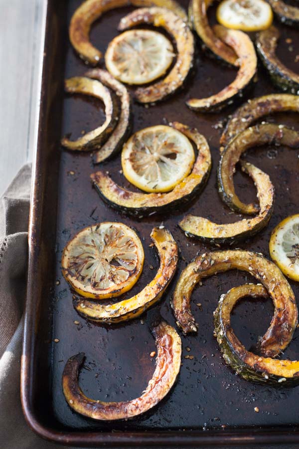 Roasted Acorn Squash with Tahini Yogurt Sauce | BourbonandHoney.com -- Seasonal Roasted Acorn Squash with Za’atar seasoning and a Tahini Yogurt Sauce; a flavorful and healthy side dish!