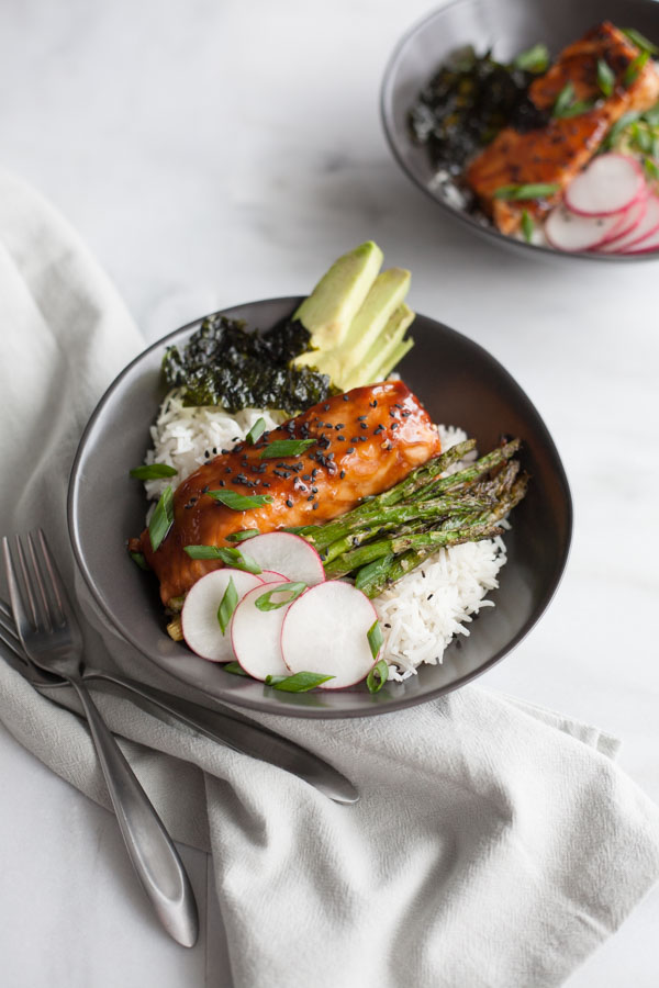 Soy Glazed Salmon Rice Bowl | BourbonandHoney.com -- Sweet and spicy soy glazed salmon topped with avocado, roasted asparagus, these salmon rice bowls are an easy favorite!