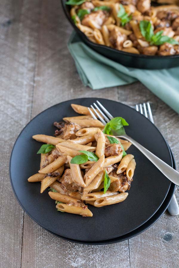 Penne with Chicken and Sun Dried Tomatoes | BourbonandHoney.com -- This Penne with Chicken dish takes dinner to the next level with a bit of cheese, sun dried tomato and some pasta for a quick and weeknight meal.