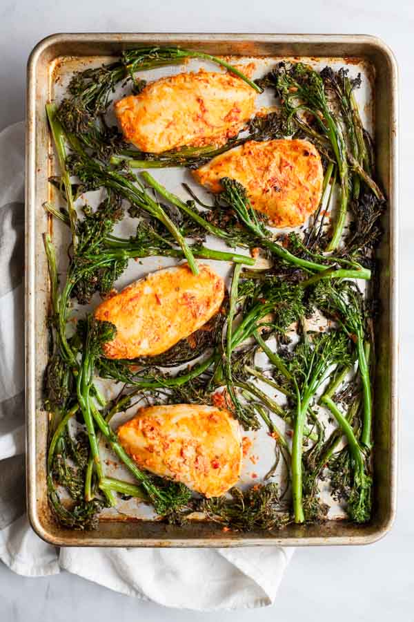 Roasted Harissa Chicken with Broccolini and Couscous | BourbonandHoney.com -- This Spicy Roasted Harissa Chicken is a super easy sheet pan supper, it's paired with broccolini and couscous and ready in about 30 minutes!