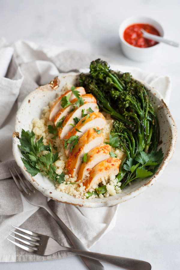 Roasted Harissa Chicken with Broccolini and Couscous | BourbonandHoney.com -- This Spicy Roasted Harissa Chicken is a super easy sheet pan supper, it's paired with broccolini and couscous and ready in about 30 minutes!