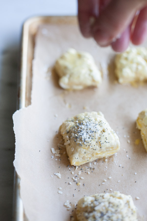 Cream Cheese Stuffed Everything Bagel Biscuits | BourbonandHoney.com -- Crunchy, salty and studded with pockets of cream cheese, these everything bagel biscuits are an impressive and delicious brunch addition.