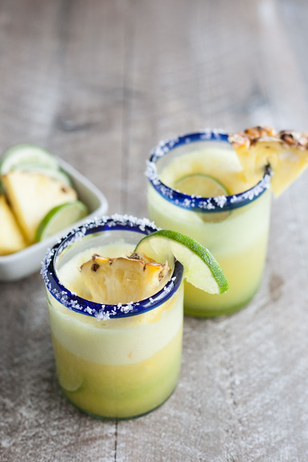 Frozen Pineapple Margaritas | BourbonandHoney.com -- Sweet, frosty and totally refreshing, these tequila spiked frozen pineapple margaritas are going to sweeten your weekend! 