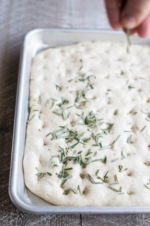 Garlic Rosemary Focaccia Bread | BourbonandHoney.com -- Garlicky, herby and delicious, this Rosemary Focaccia Bread is soft, rich and chewy and perfect for pizza crust, snacking or sandwiches.