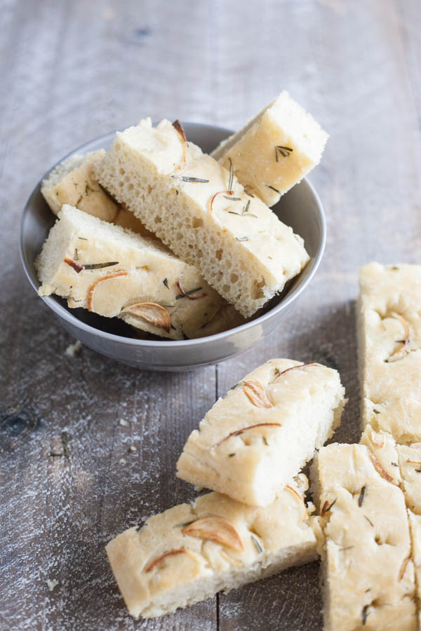 Garlic Rosemary Focaccia Bread | BourbonandHoney.com -- Garlicky, herby and delicious, this Rosemary Focaccia Bread is soft, rich and chewy and perfect for pizza crust, snacking or sandwiches.