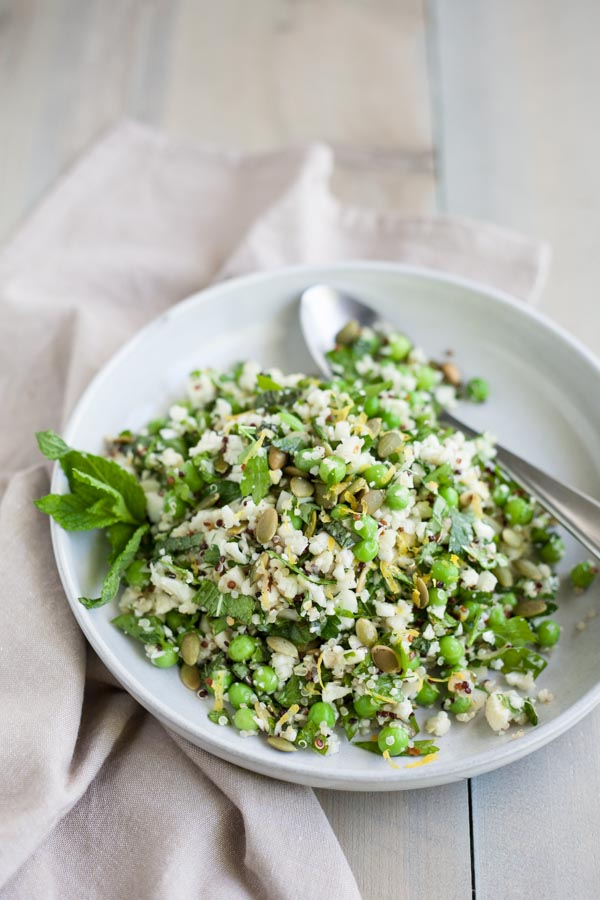 Quinoa Cauliflower Tabbouleh Salad | BourbonandHoney.com -- This Cauliflower Tabbouleh Salad is a fresh spring dish of cauliflower and quinoa paired with herbs, fresh peas, lemon and toasted pepitas.