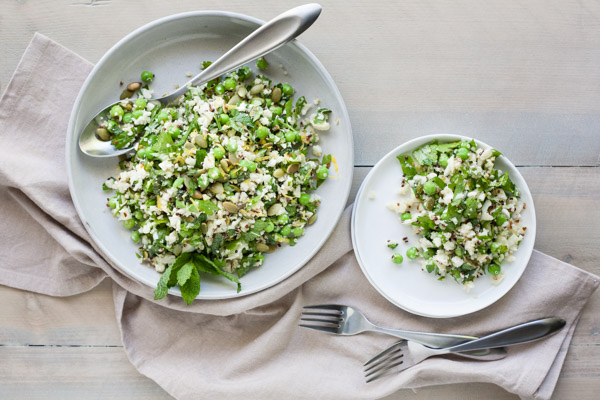 Quinoa Cauliflower Tabbouleh Salad | BourbonandHoney.com -- This Cauliflower Tabbouleh Salad is a fresh spring dish of cauliflower and quinoa paired with herbs, fresh peas, lemon and toasted pepitas.