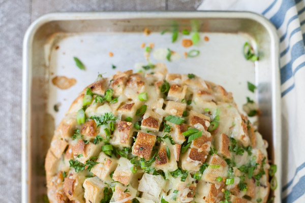 Cheesy Pull-Apart Garlic Bread | BourbonandHoney.com -- This over-the-top Cheesy Pull-Apart Garlic Bread is super cheesy, garlicky and totally delicious! Make it as a side with dinner or as a tasty appetizer.