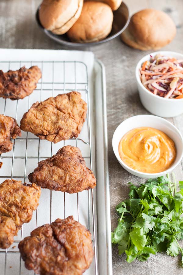 Korean Fried Chicken Sandwich | BourbonandHoney.com -- This Korean Fried Chicken Sandwich is spicy, flavorful and delicious. Topped with a kimchi slaw and gochujang aioli, it's irresistible!