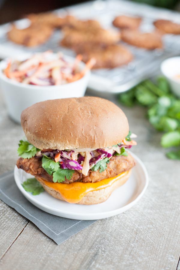 Korean Fried Chicken Sandwich | BourbonandHoney.com -- This Korean Fried Chicken Sandwich is spicy, flavorful and delicious. Topped with a kimchi slaw and gochujang aioli, it's irresistible!