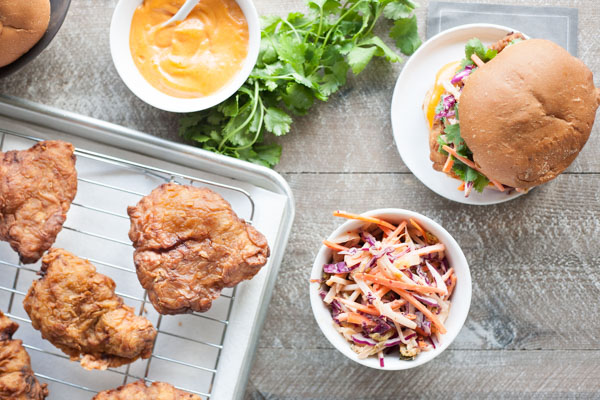 Korean Fried Chicken Sandwich | BourbonandHoney.com -- This Korean Fried Chicken Sandwich is spicy, flavorful and delicious. Topped with a kimchi slaw and gochujang aioli, it's irresistible!