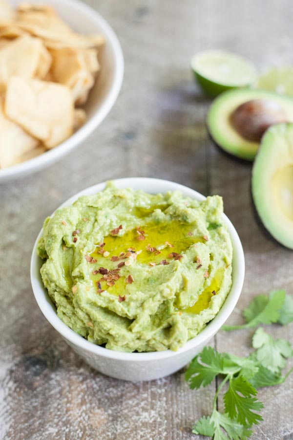 Spicy Avocado Hummus | BourbonandHoney.com -- Rich, creamy and garlicky, this avocado hummus is packed with chickpeas, tahini, a squeeze of lime juice and just the right amount of spice.