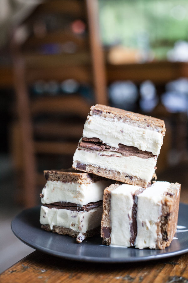 Nutella and Chocolate Chip Cookie Ice Cream Sandwiches | BourbonandHoney.com -- These simple, 3-ingreditent Chocolate Chip Cookie Ice Cream Sandwiches are layered with Nutella and a great way to cool down a crowd with an indulgent summer treat.