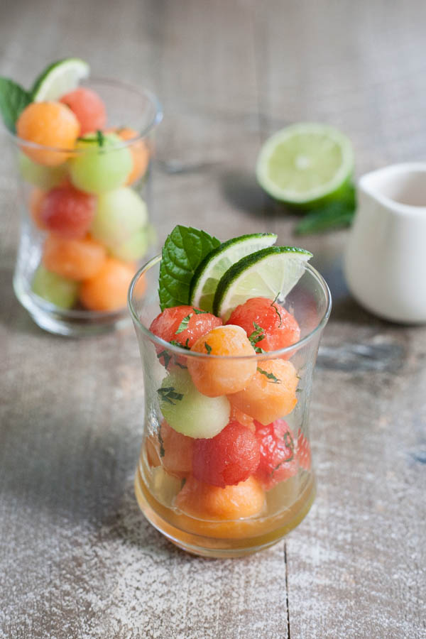 Bourbon and Honey Melon Balls | BourbonandHoney.com -- Boozy, frosty and super refreshing these Bourbon and Honey Melon Balls with fresh mint and lime are the perfect summer happy hour snack.