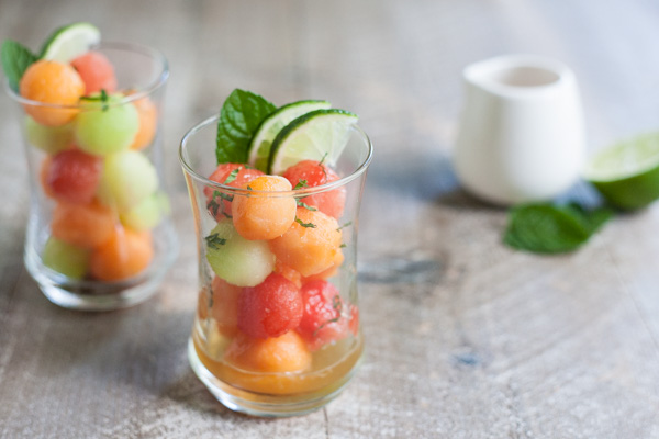 Bourbon and Honey Melon Balls | BourbonandHoney.com -- Boozy, frosty and super refreshing these Bourbon and Honey Melon Balls with fresh mint and lime are the perfect summer happy hour snack.