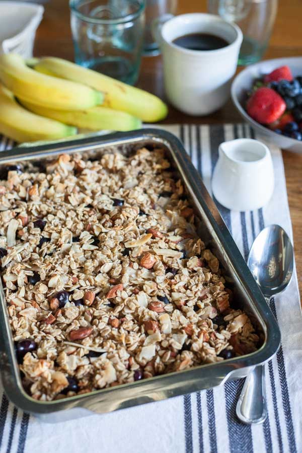 Coconut Baked Oatmeal with Berries | BourbonandHoney.com -- A warm, fruity and hearty Coconut Baked Oatmeal with Berries, almonds and bananas. It's the perfect recipe for a lazy weekend brunch!