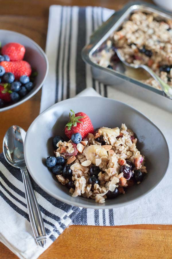 Coconut Baked Oatmeal with Berries | BourbonandHoney.com -- A warm, fruity and hearty Coconut Baked Oatmeal with Berries, almonds and bananas. It's the perfect recipe for a lazy weekend brunch!