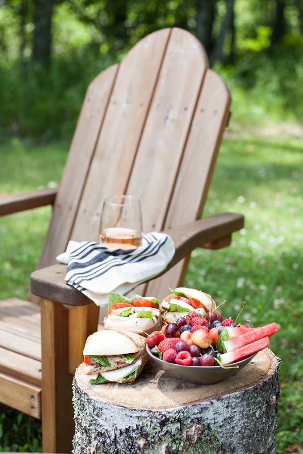 Picnic Perfect Caprese Chicken Sandwich | BourbonandHoney.com -- Seasoned chicken, pesto aioli, summery tomatoes, fresh basil and lots of cheese make these Caprese Chicken Sandwiches quick, delicious and picnic ready!