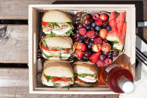 Picnic Perfect Caprese Chicken Sandwich | BourbonandHoney.com -- Seasoned chicken, pesto aioli, summery tomatoes, fresh basil and lots of cheese make these Caprese Chicken Sandwiches quick, delicious and picnic ready!