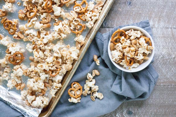 Bourbon and Honey Caramel Corn | BourbonandHoney.com -- Salty pretzels and crunchy nuts make this Bourbon and Honey Caramel Corn perfectly sweet and salty for a delicious food gift of tasty snack!