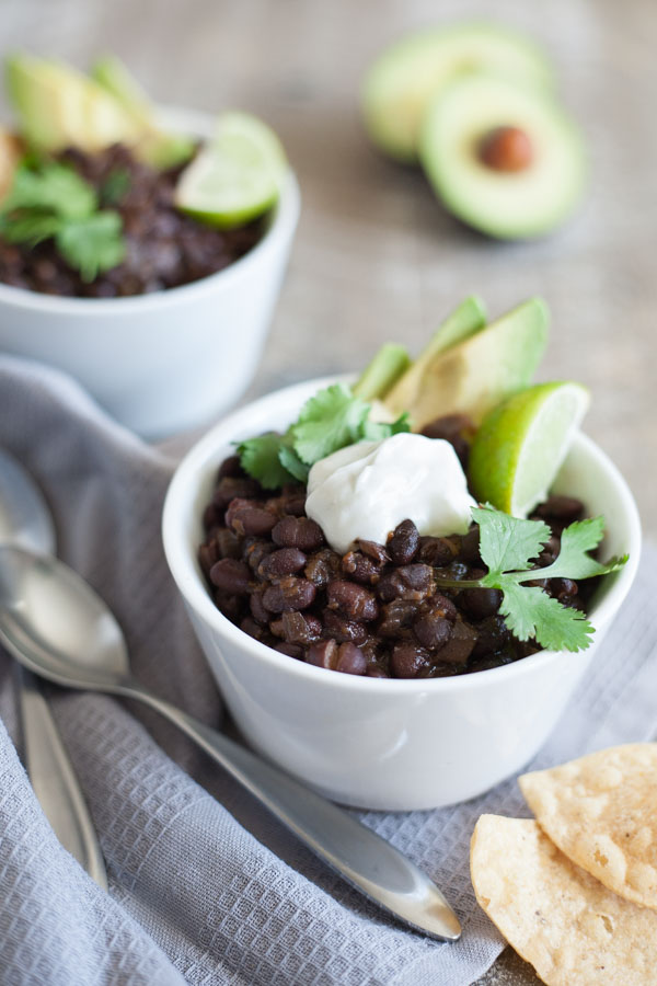 Spicy Slow Cooker Black Beans | BourbonandHoney.com -- This Spicy Slow Cooker Black Bean recipe is quick, flavorful and super easy to customize. Serve it with rice, tortilla chips and all your favorite toppers.