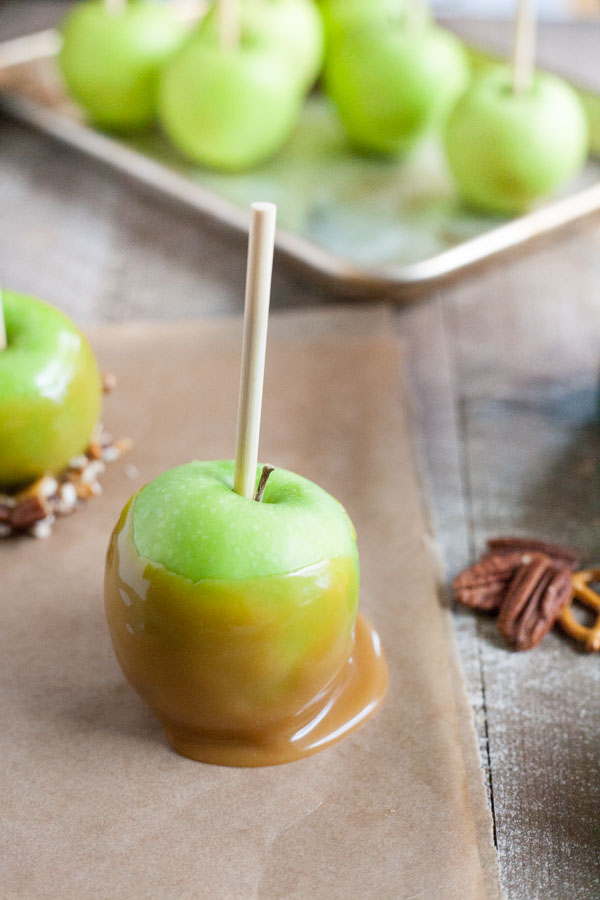 Bourbon and Honey Caramel Apples | BourbonandHoney.com -- Sweet, spiked and perfect for a chilly fall, these Bourbon and Honey Caramel Apples are a great homemade sweet treat or snack!