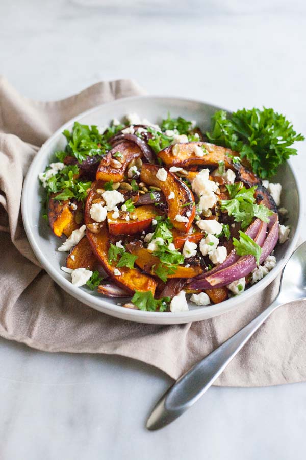 Spicy Roasted Pumpkin with Honey and Feta | BourbonandHoney.com -- This Spicy Roasted Pumpkin recipe is a quick and easy gluten free side dish with sweet caramelized honey, feta cheese and pumpkin seeds.