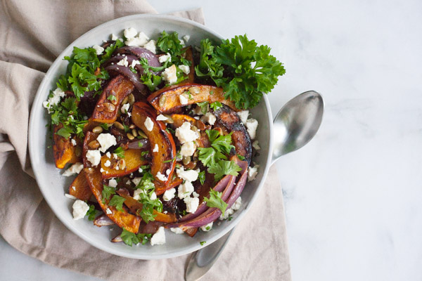 Spicy Roasted Pumpkin with Honey and Feta | BourbonandHoney.com -- This Spicy Roasted Pumpkin recipe is a quick and easy gluten free side dish with sweet caramelized honey, feta cheese and pumpkin seeds.