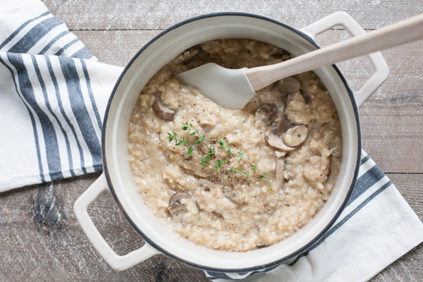 Easy Oven Risotto with Mushrooms | BourbonandHoney.com -- Creamy, cheesy and oh-so comforting, this Easy Oven Risotto with mushrooms is so quick to make that you can even serve it during the week!