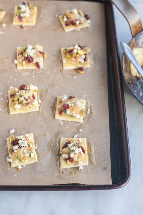 Caramelized Onion Apple Tarts with Blue Cheese and Cranberries | BourbonandHoney.com -- These super flavorful Caramelized Onion and Apple Tarts with Blue Cheese and Cranberries are the perfect bite sized appetizer!