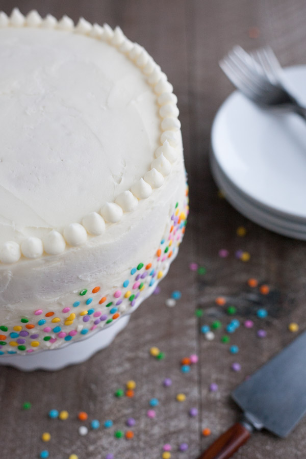 Champagne Cake with Buttercream Frosting | BourbonandHoney.com -- This Champagne Cake with Buttercream Frosting is the perfect cake recipe to celebrate with! It's light, tender, sweet and spiked with champagne!