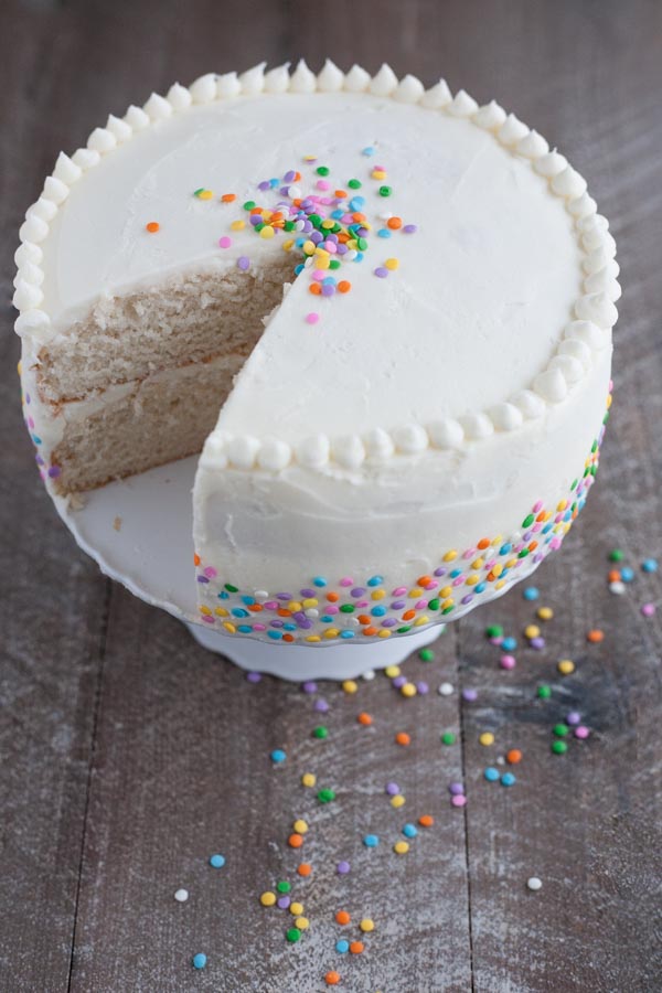 Champagne Cake with Buttercream Frosting | BourbonandHoney.com -- This Champagne Cake with Buttercream Frosting is the perfect cake recipe to celebrate with! It's light, tender, sweet and spiked with champagne!