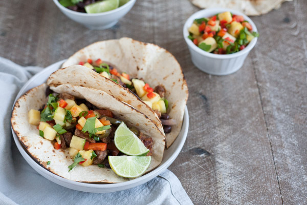 Slow Cooker Jamaican Jerk Chicken Tacos | BourbonandHoney.com -- Spicy, sweet and super flavorful, these Slow Cooker Jamaican Jerk Chicken Tacos are an easy make ahead dinner that can serve a crowd!