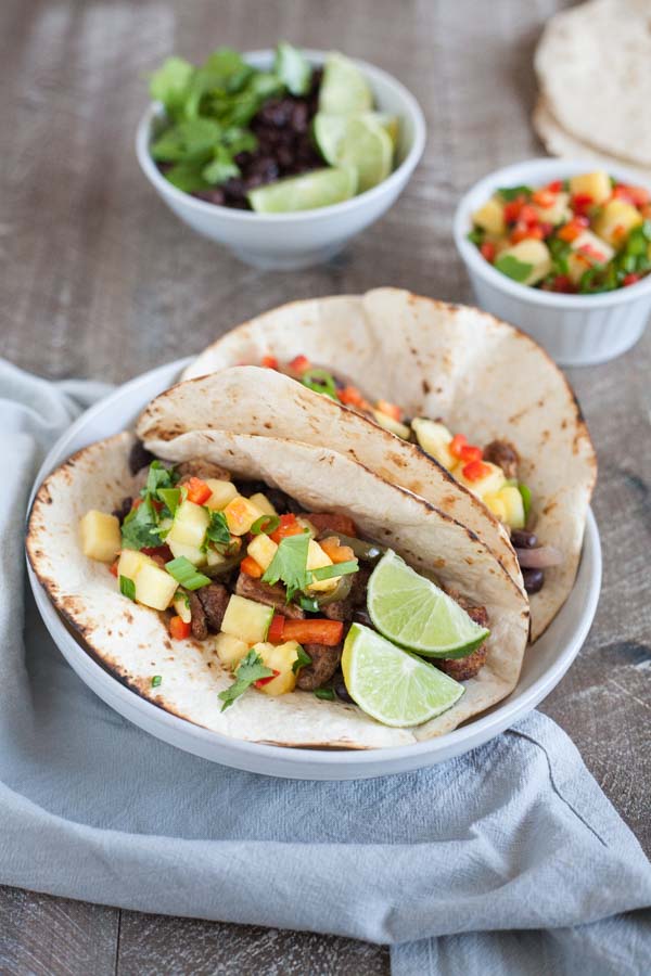 Slow Cooker Jamaican Jerk Chicken Tacos | BourbonandHoney.com -- Spicy, sweet and super flavorful, these Slow Cooker Jamaican Jerk Chicken Tacos are an easy make ahead dinner that can serve a crowd!