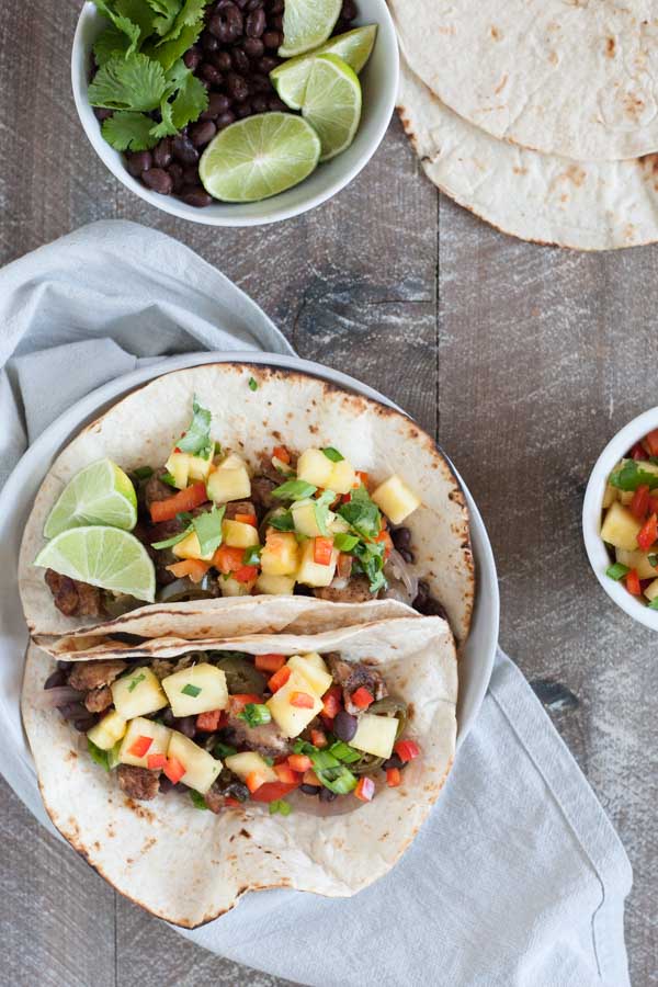 Slow Cooker Jamaican Jerk Chicken Tacos | BourbonandHoney.com -- Spicy, sweet and super flavorful, these Slow Cooker Jamaican Jerk Chicken Tacos are an easy make ahead dinner that can serve a crowd!