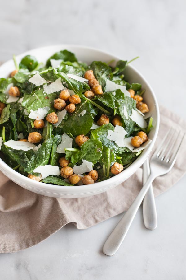 Baby Kale Salad with Crispy Parmesan Chickpeas | BourbonandHoney.com -- Simple, flavorful and impossibly easy, this Baby Kale Salad with Crispy Parmesan Chickpeas recipe is my go-to for both weeknight meals and dinner parties.