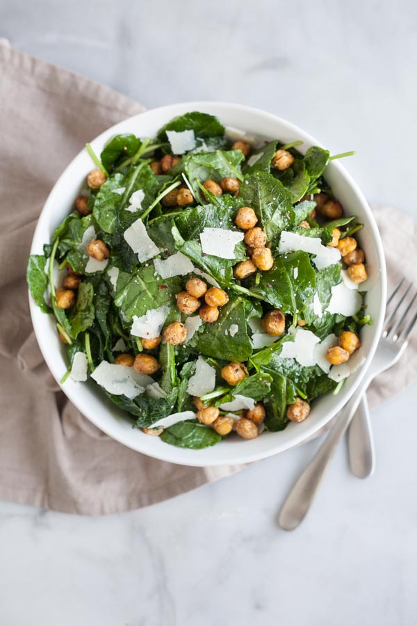 Baby Kale Salad with Crispy Parmesan Chickpeas | BourbonandHoney.com -- Simple, flavorful and impossibly easy, this Baby Kale Salad with Crispy Parmesan Chickpeas recipe is my go-to for both weeknight meals and dinner parties.