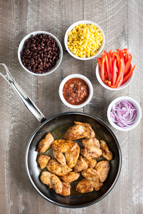 Easy Skillet Chicken with Black Beans and Corn | BourbonandHoney.com -- Spicy, delicious and on the table in 20 minutes, this Easy Skillet Chicken recipe is a serious weeknight winner and a quick family favorite!