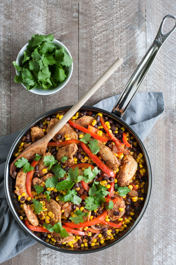 Easy Skillet Chicken with Black Beans and Corn | BourbonandHoney.com -- Spicy, delicious and on the table in 20 minutes, this Easy Skillet Chicken recipe is a serious weeknight winner and a quick family favorite!