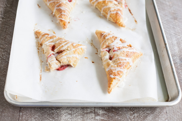 Easy Strawberry Rhubarb Turnovers | BourbonandHoney.com -- Sweet, tart and perfectly flaky these Strawberry Rhubarb Turnovers are a deliciously easy spring treat or brunch recipe!