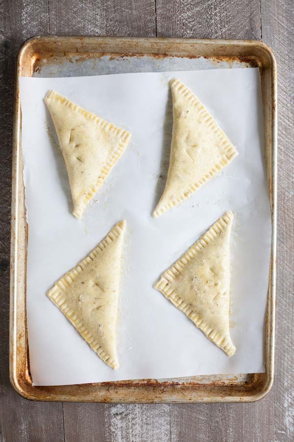 Easy Strawberry Rhubarb Turnovers | BourbonandHoney.com -- Sweet, tart and perfectly flaky these Strawberry Rhubarb Turnovers are a deliciously easy spring treat or brunch recipe!