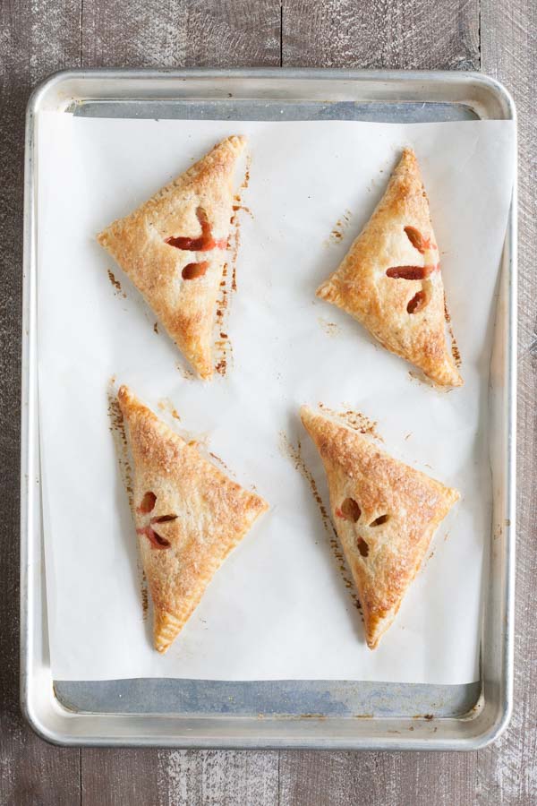 Easy Strawberry Rhubarb Turnovers | BourbonandHoney.com -- Sweet, tart and perfectly flaky these Strawberry Rhubarb Turnovers are a deliciously easy spring treat or brunch recipe!