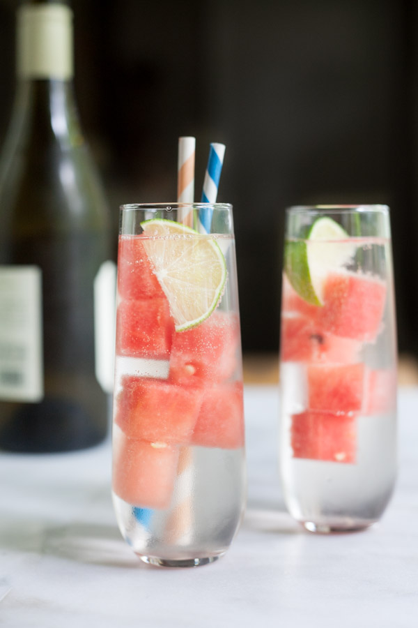 Fresh Watermelon White Wine Spritzer | BourbonandHoney.com -- This simple, refreshing and low alcohol white wine spritzer is chilled with frozen watermelon for the perfect warm weather cocktail.