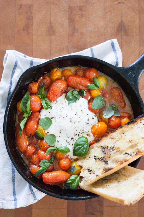 Grilled Tomatoes with Burrata and Basil | BourbonandHoney.com -- This summery skillet recipe of Grilled Tomatoes with Burrata and Basil is a great appetizer, light lunch or dinner served over pasta!