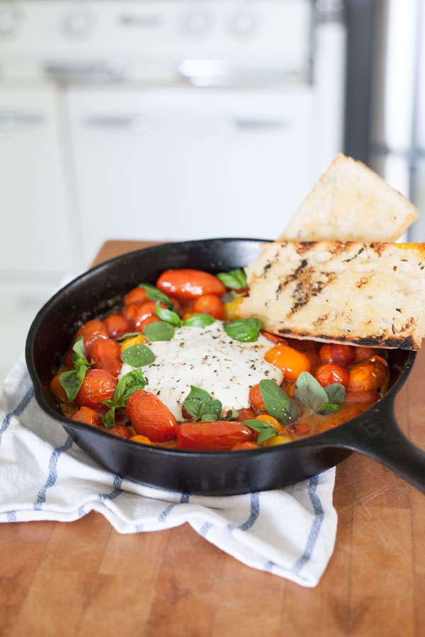 Grilled Tomatoes with Burrata and Basil | BourbonandHoney.com -- This summery skillet recipe of Grilled Tomatoes with Burrata and Basil is a great appetizer, light lunch or dinner served over pasta!