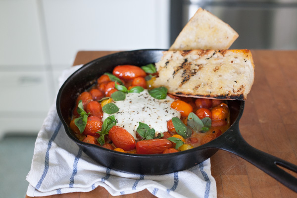 Grilled Tomatoes with Burrata and Basil | BourbonandHoney.com -- This summery skillet recipe of Grilled Tomatoes with Burrata and Basil is a great appetizer, light lunch or dinner served over pasta!