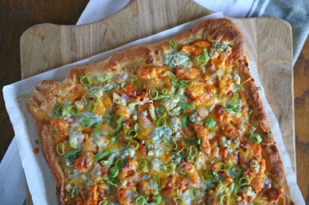 Buffalo Chicken Pizza | BourbonAndHoney.com -- A spicy buffalo chicken pizza topped with layers of cheese. The perfect dinner for buffalo wing lovers or appetizer for a crowd on game day.